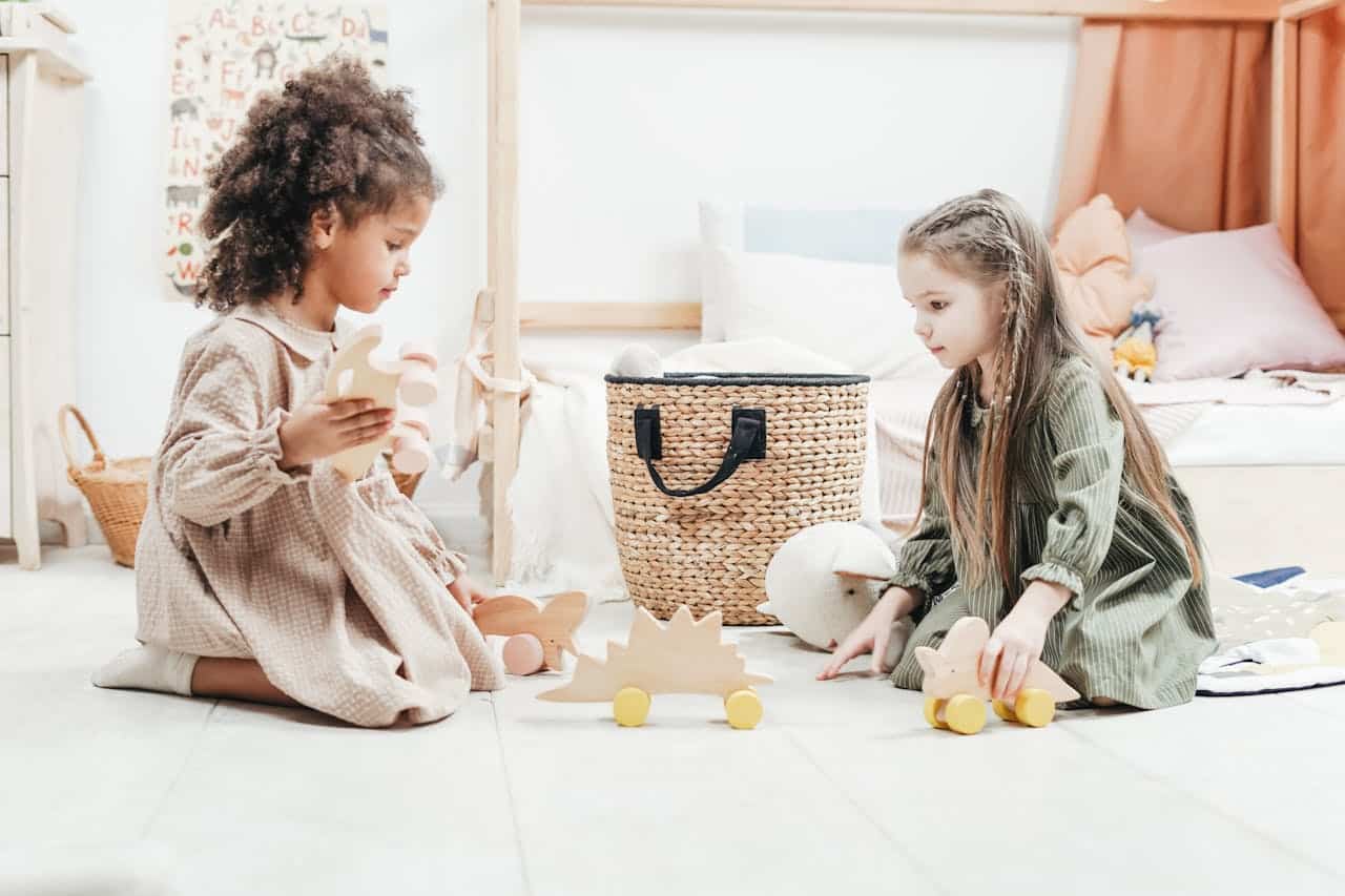 two girls playing with toy horses