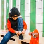 Kid tying shoes for aba therapy and motor skills