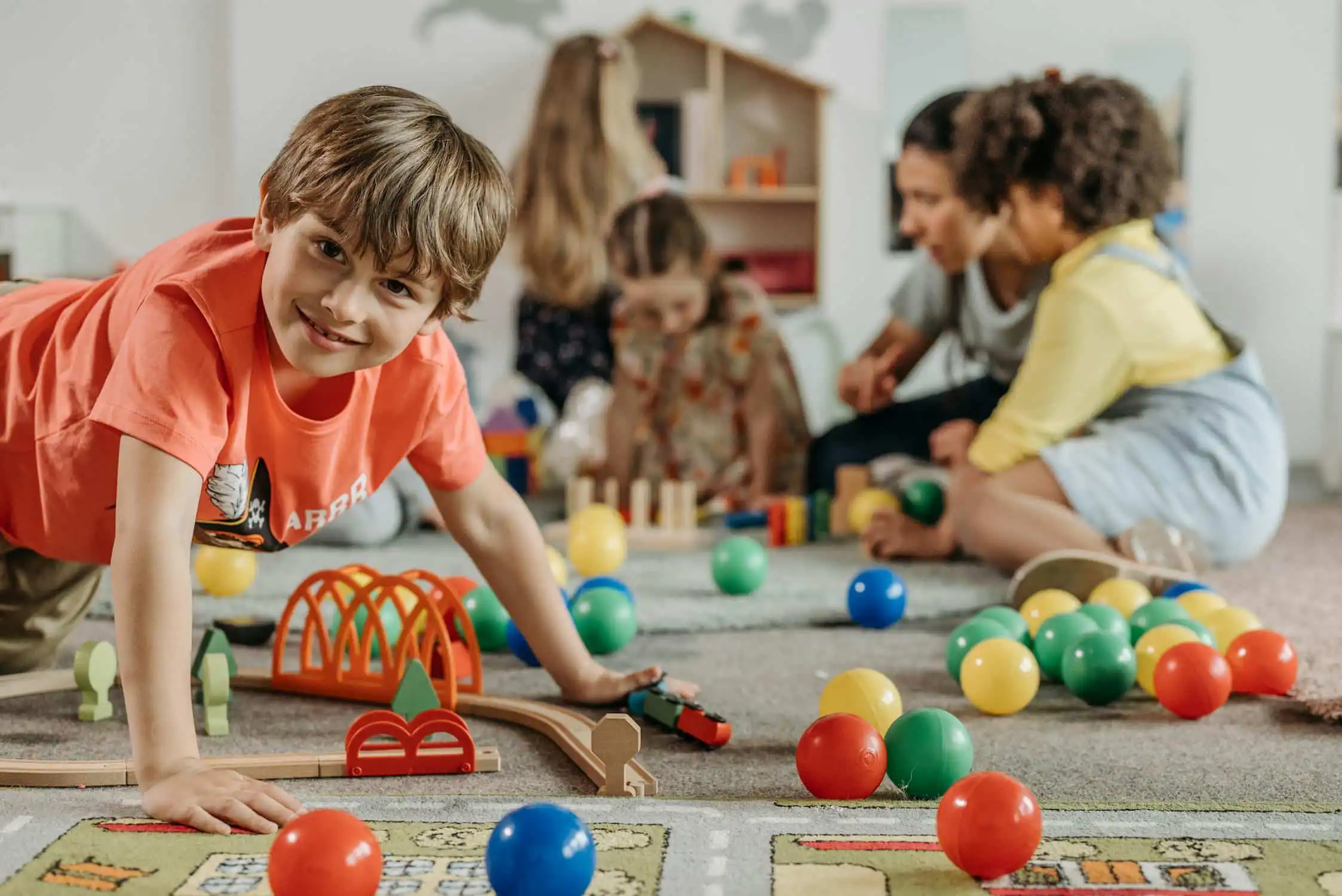 mental health service with Boy in Orange Shirt Playing on the Floor