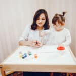 A little girl with autism and her therapist during their ABA therapy session