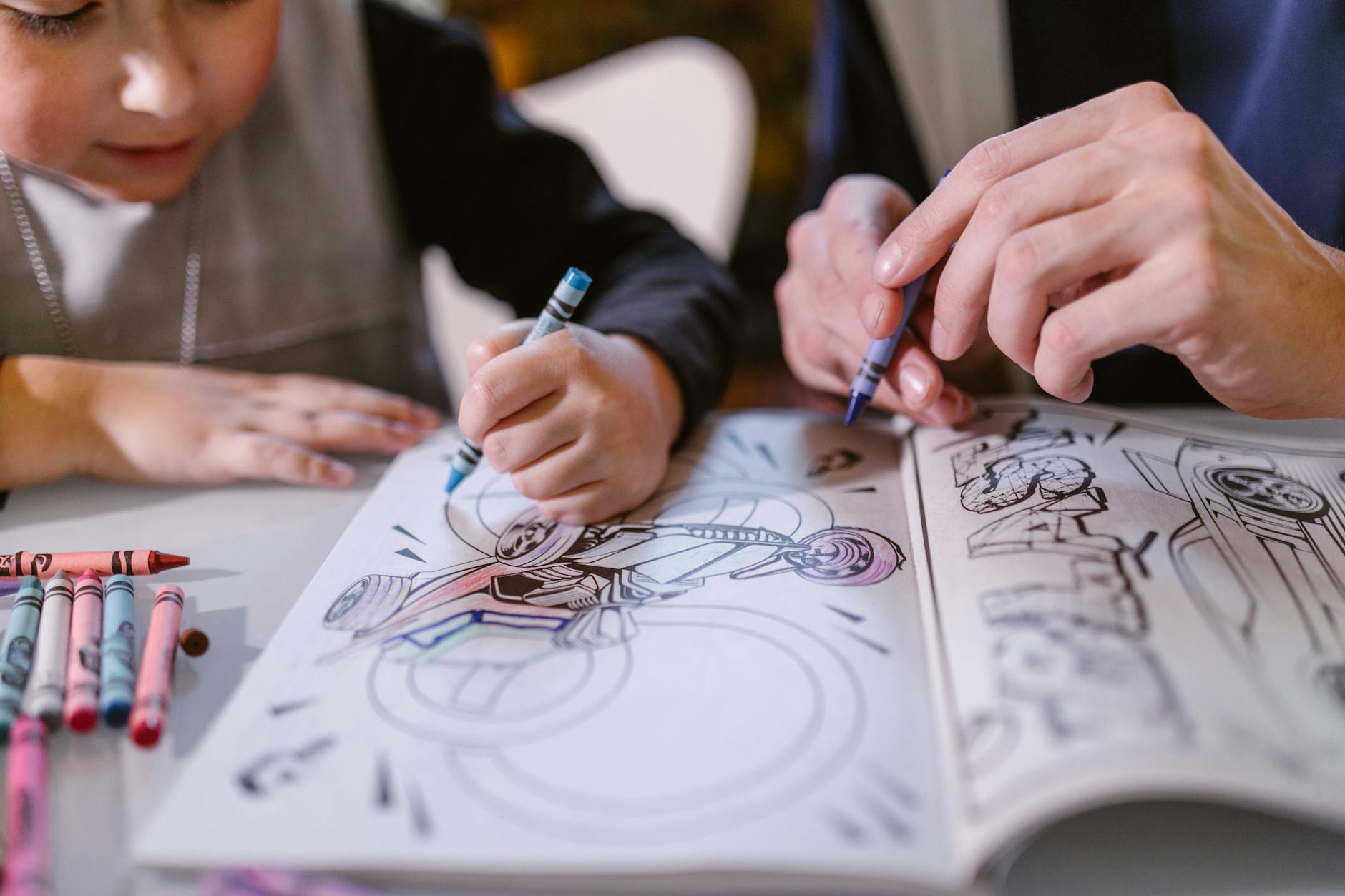 Close-up of hands of an RBT and autistic child coloring a picture in a coloring book in Maryland.