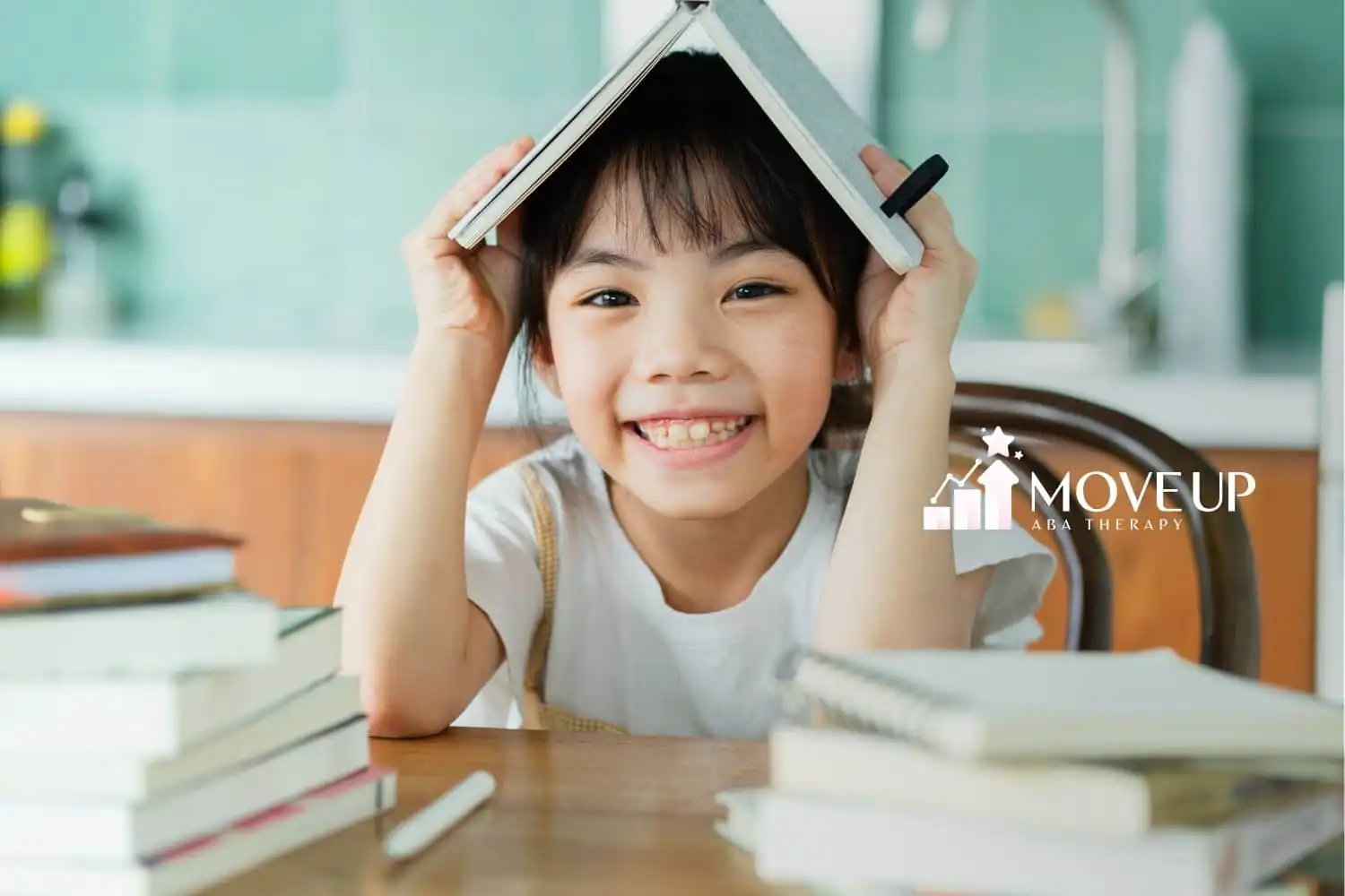 A boy holding a book above his head
