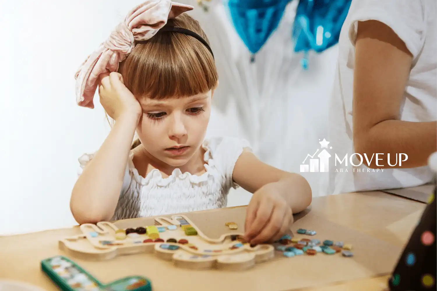 An autistic child doing crafts on a table