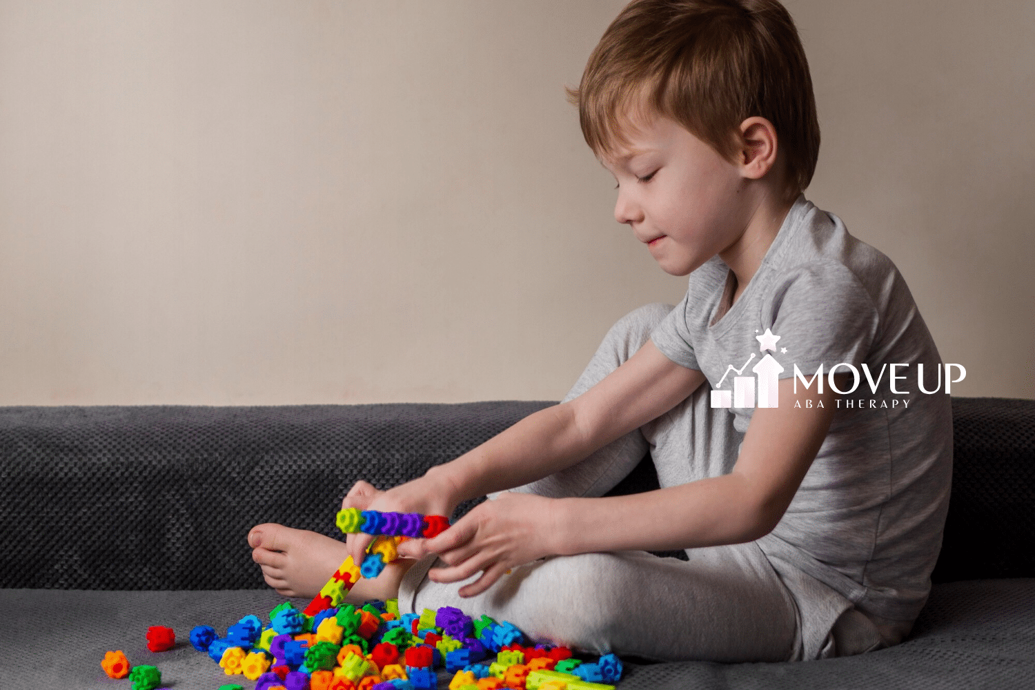 A boy with autism is playing with colorful blocks