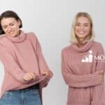 Two woman wearing pink sweater looking uncomfortable