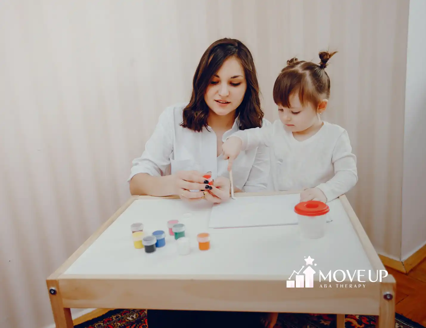 A child and an RBT during ABA therapy