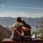 An autistic couple sitting on a bench overlooking a scenic mountain and lake landscape in Maryland.