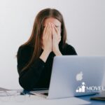 Frustrated BCBA student covering face while checking BCBA exam results on her laptop in Virginia.