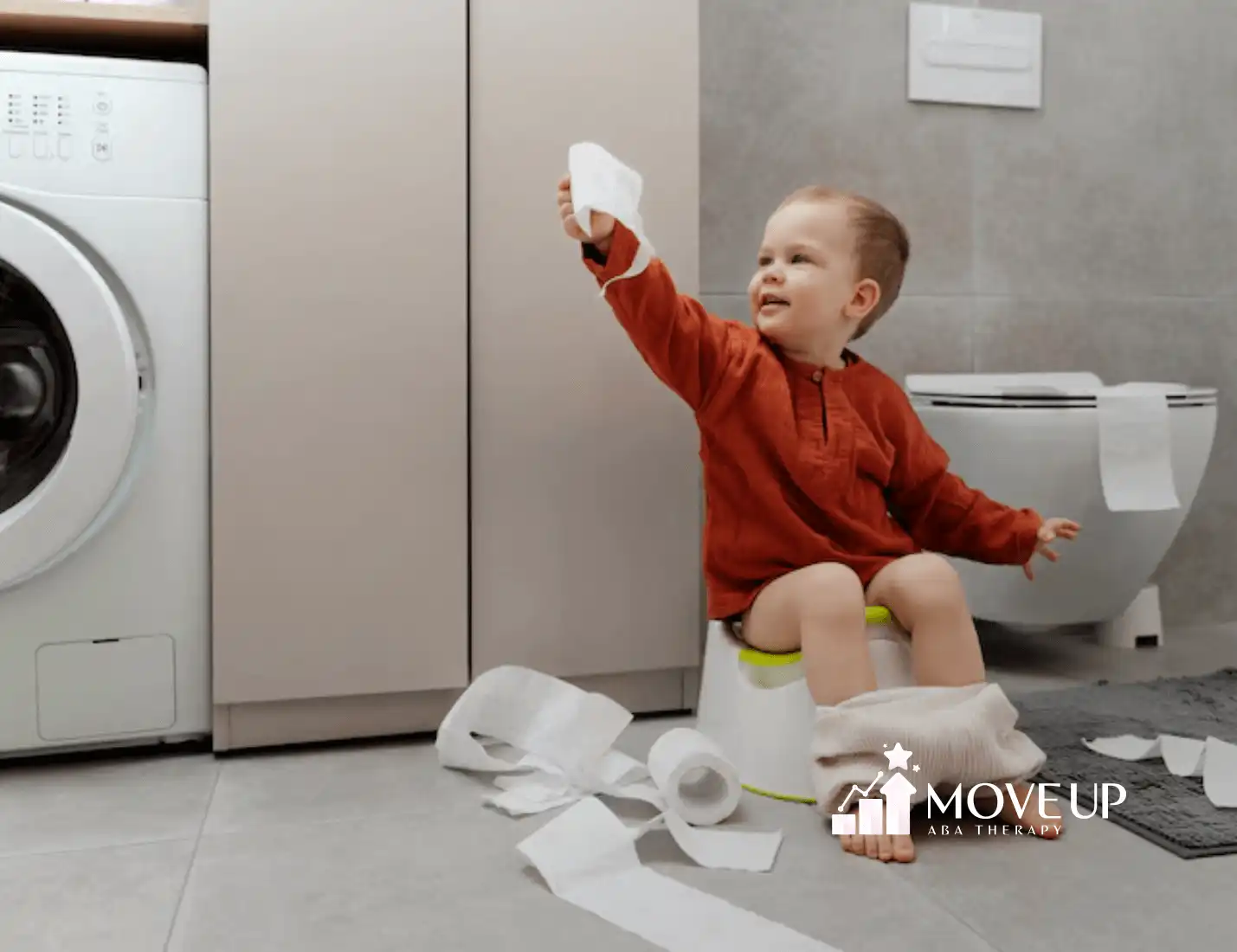 An child with autism potty training while sitting on a portable child urinal holding tissues