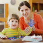 A child with autism and her RBT doing hand painting during ABA therapy
