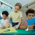 Three autistic kids focused on a paper craft activity at an art table during center-based ABA therapy in Maryland.