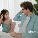 A girl with autism and an ABA therapist playing a learning game together in ABA therapy.
