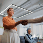 An autistic adult shaking hands with her employer