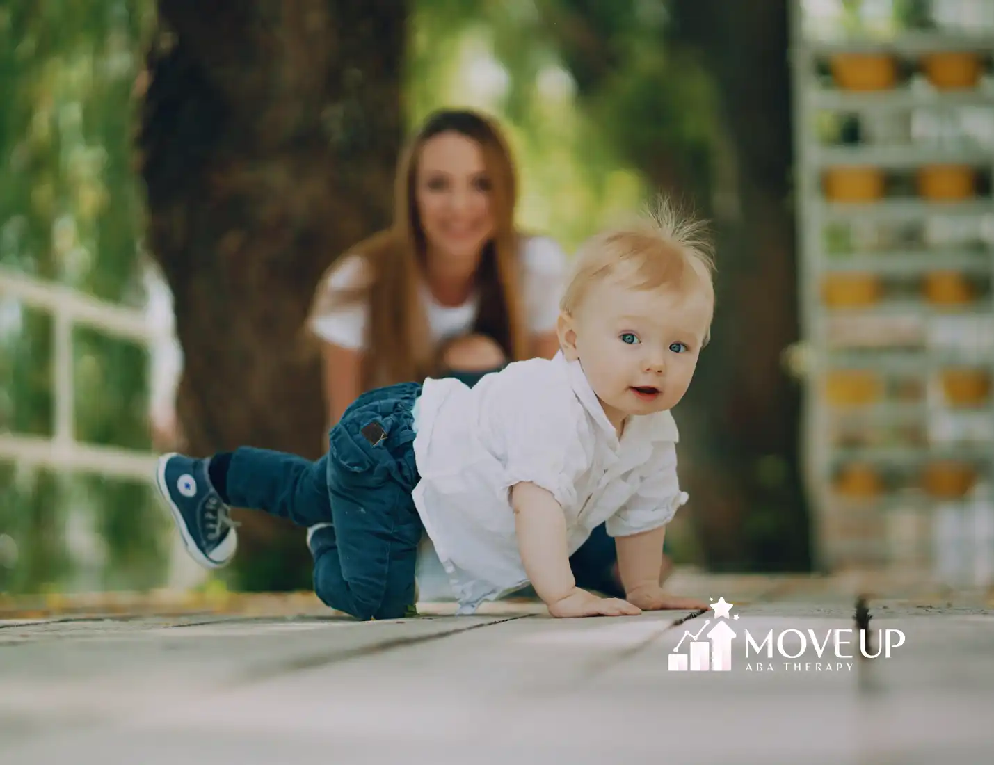 A one-year-old toddler is crawling while his mom is watching