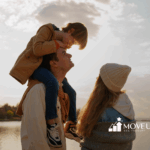A happy family watching the sunset by the lake