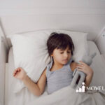 Autistic child sleeping peacefully with sensory-friendly bed and comfort toy.