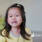 Autistic child experiencing a meltdown, supported through ABA therapy strategies.